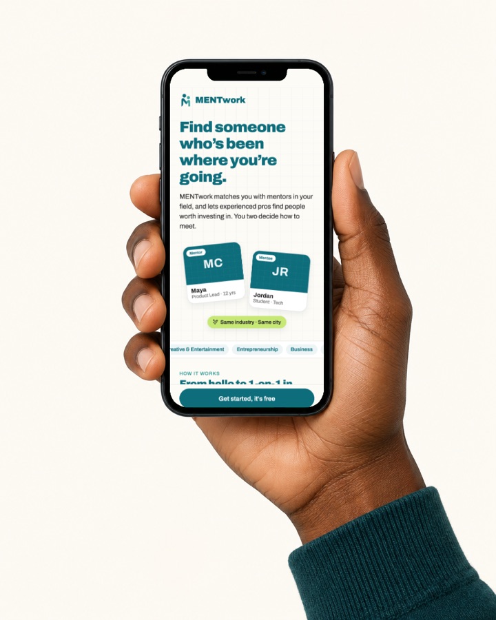 A hand holding a phone showing the MENTwork app