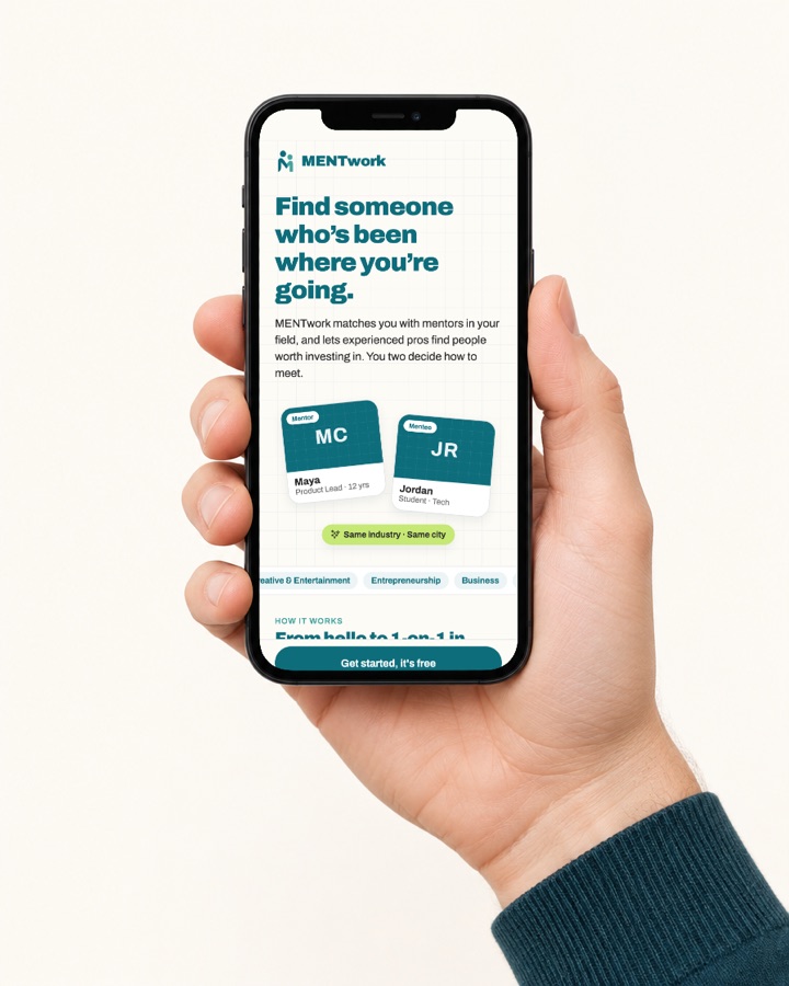 A hand holding a phone showing the MENTwork app